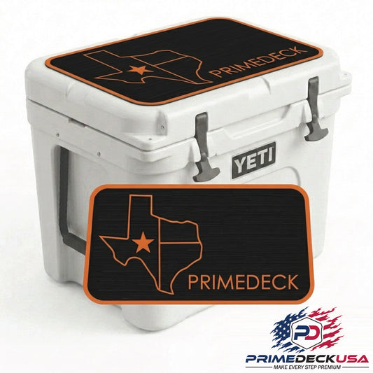 A white YETI cooler with a black and orange Texas-shaped mat featuring the brand name 'PRIMEDECK' on the lid, with a matching floor mat shown in front on a white background.