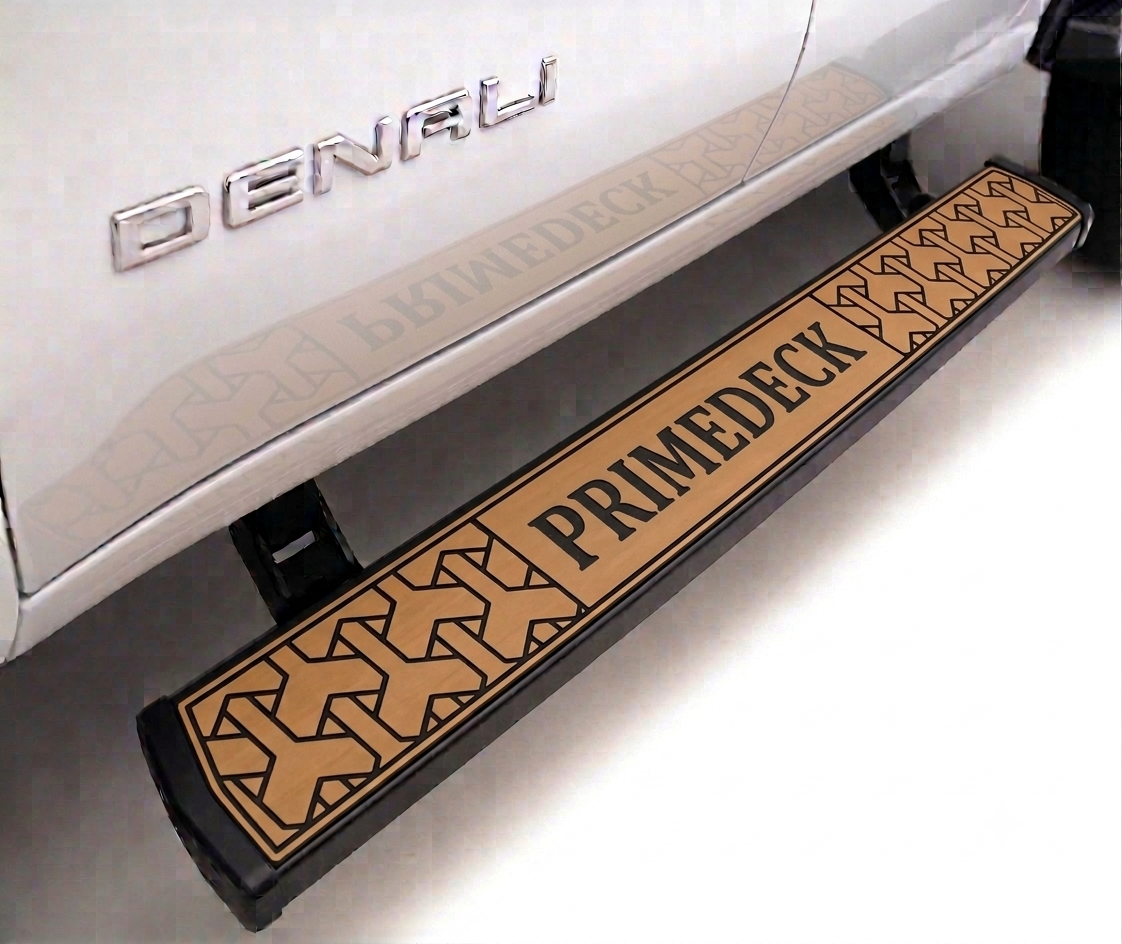 A tan and black PrimeDeck vehicle step bumper mounted under a white Denali truck, shown in a close-up product shot.